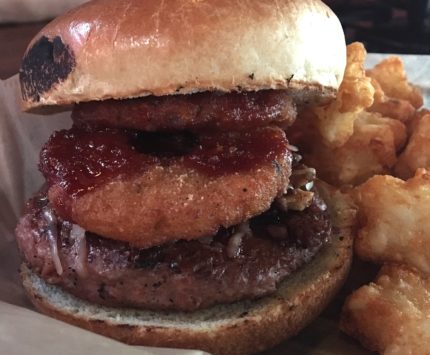 A veggie burger with a side of tots