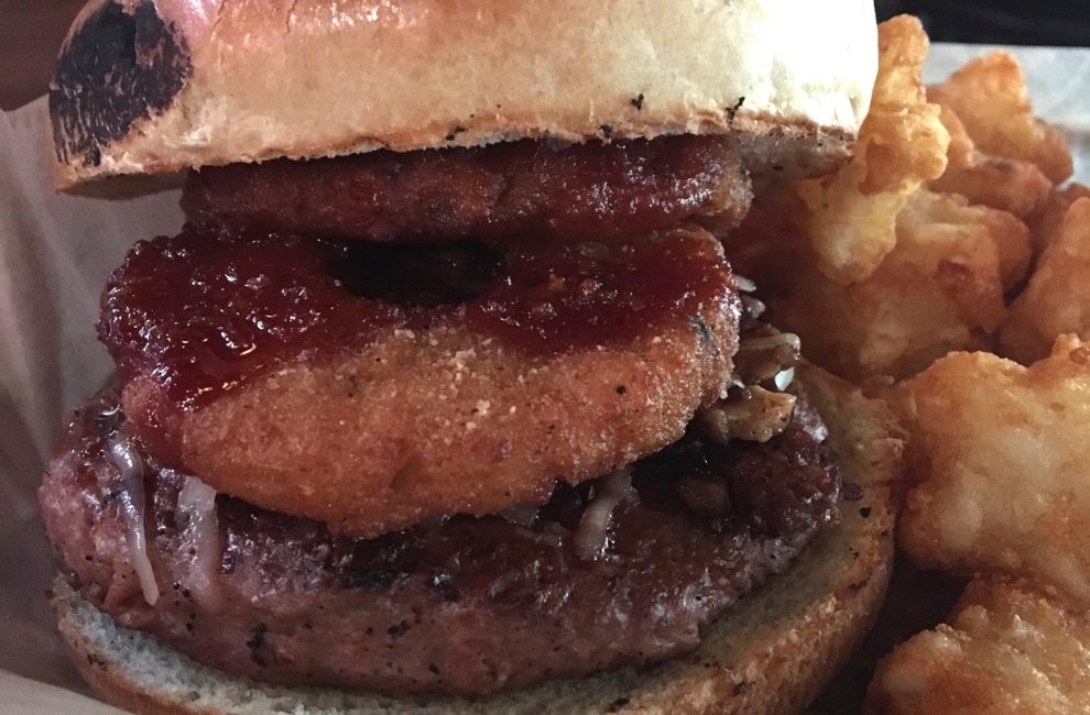 A veggie burger with a side of tots