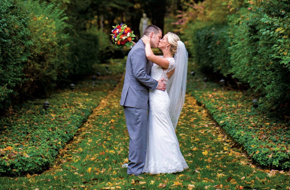 Bride and groom kissing in beautiful scene