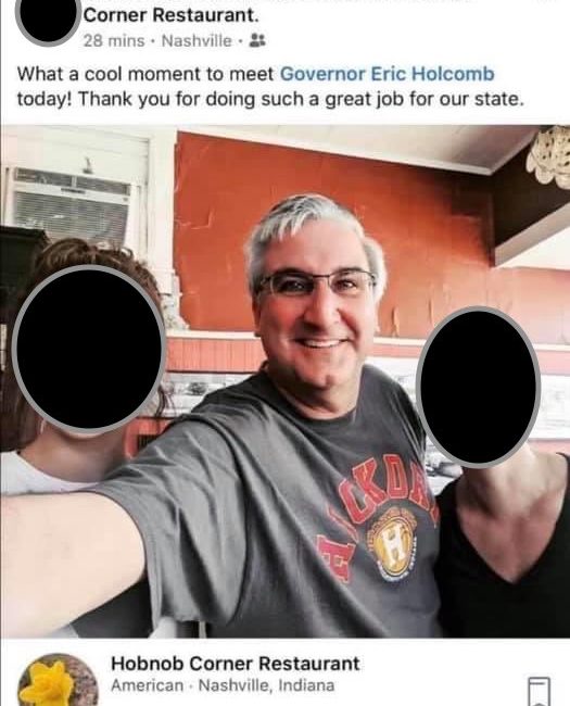 Governor Eric Holcomb taking a photo with supporters.