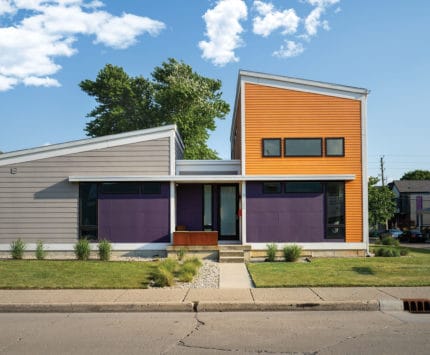 Exterior of modern home painted bright orange and purple