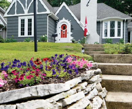 Exterior of blue cottage with red door