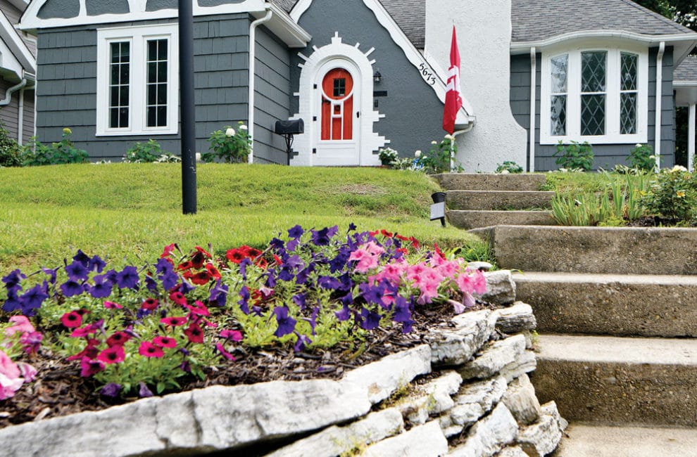 Exterior of blue cottage with red door