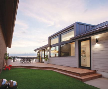 Exterior of contemporary lakehouse at sunset