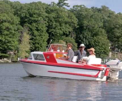 A candy-colored boat with tailfins cruises the Kalamazoo River.