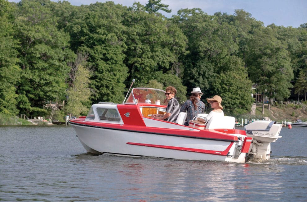 A candy-colored boat with tailfins cruises the Kalamazoo River.