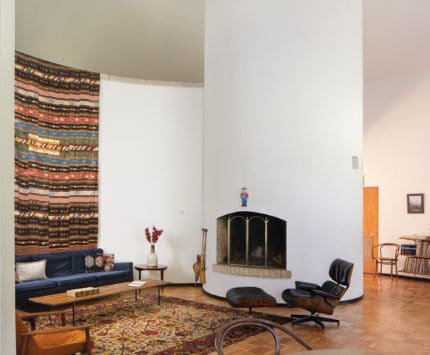 An interior living room with round fireplace