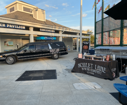 A hearse sits outside the Children's Museum at a Scarlet Lane Brewing event.