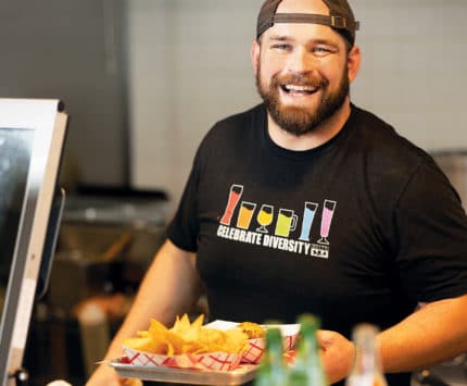 photo of smiling man in a backwards hat