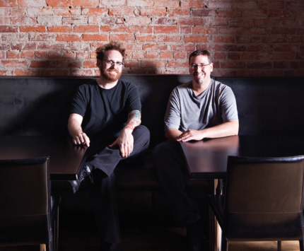 Ed Rudisell and Micah Frank sitting at a table