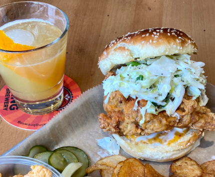 A chicken sandwich and a cocktail