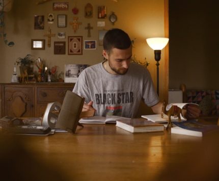 A man reading a book at a table