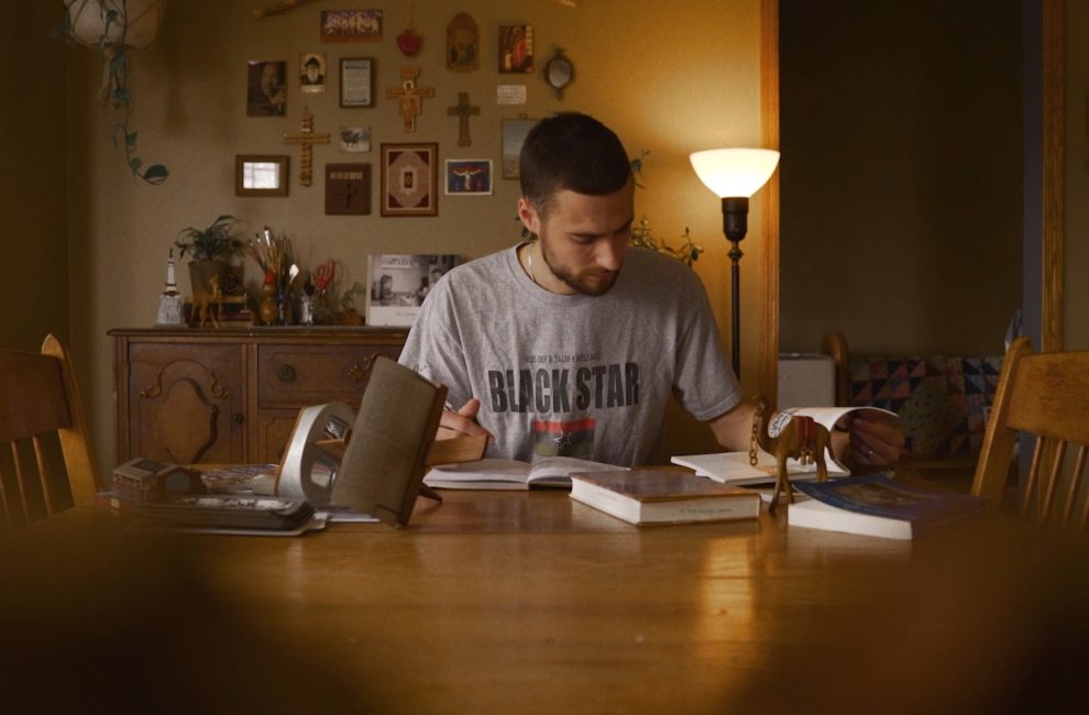 A man reading a book at a table