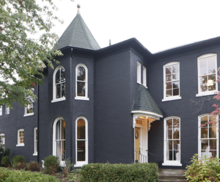 A home in terre haute with dark paint and a yellow door