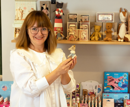 A woman holding a toy in a toy store