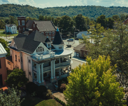 a white main street mansion in Brookville