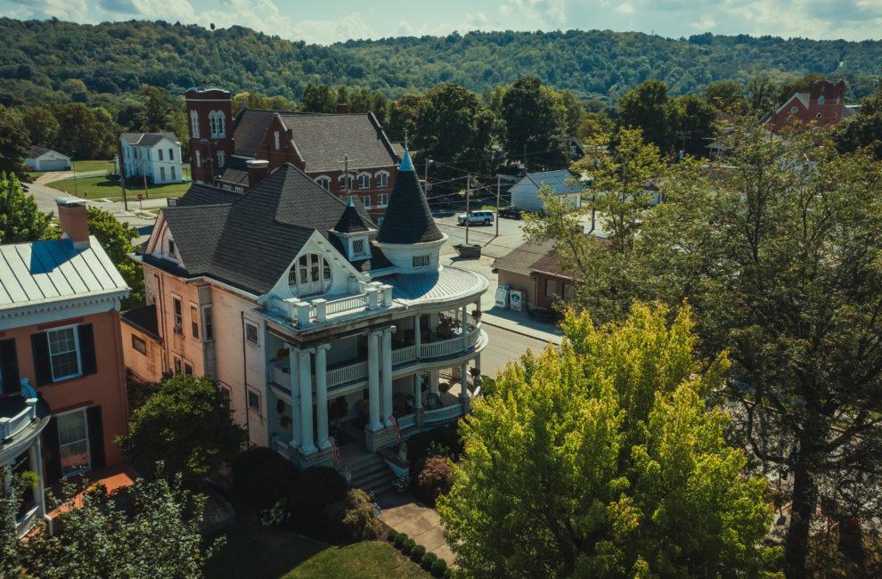 a white main street mansion in Brookville