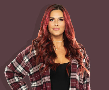 a woman with red hair in plaid