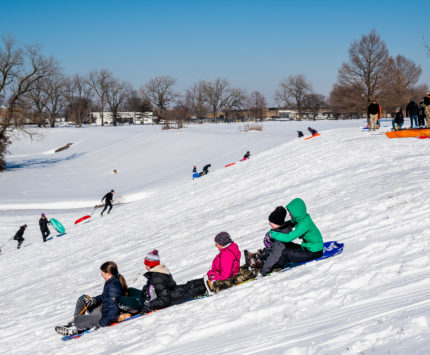 People sledding down a hill