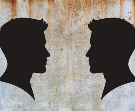 Two men in profile silhouettes looking at each other