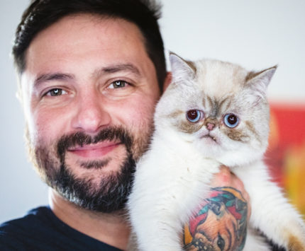 Mike Bridavsky holding his cat Mr. Marbles