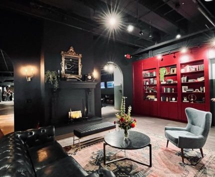 A room with dark walls and red shelving