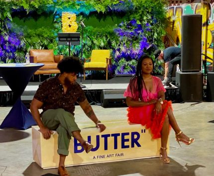 GANGGANG founders Alan Bacon and Mali Jeffers sitting on a stick of Butter