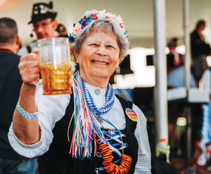 A woman holding a beer at Oktoberfest