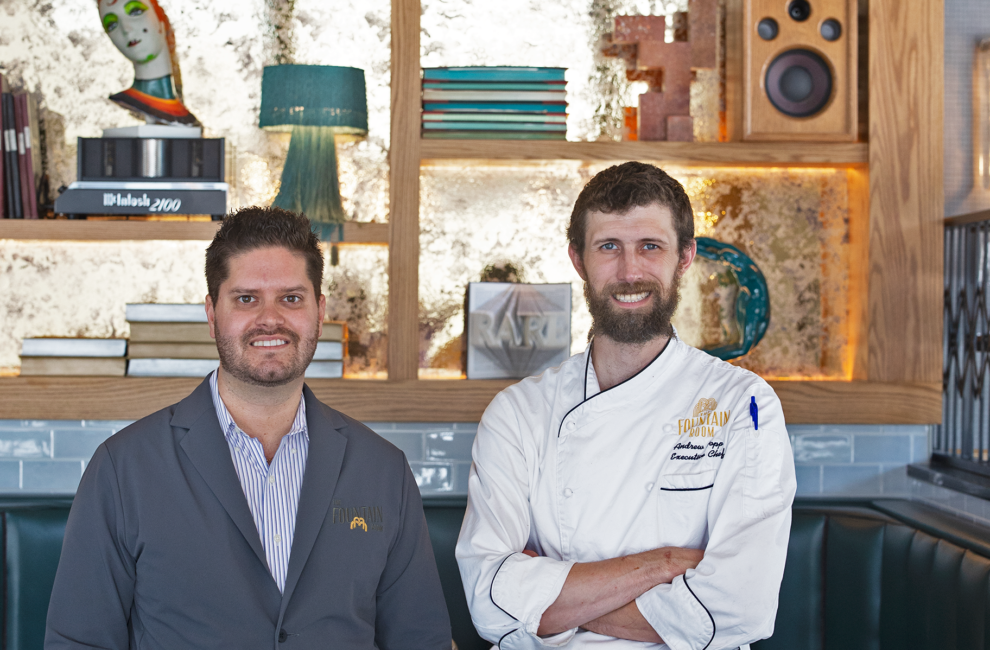 Owner Blake Fogelsong and executive chef Andrew pose in front of a wall with Tchotchkes