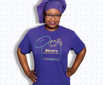 a woman in a purple shirt and purple chef's hat