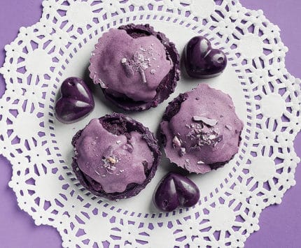 Ube Love's candies resting on a doily on a purple table