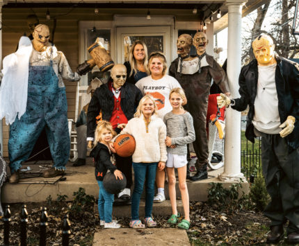 A family poses with their Halloween decorations on their front porch for our Spookiest Homes of Indy photo gallery