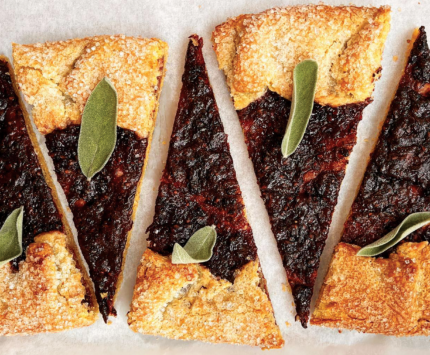 Blackberry Sage Galette slices on a parchment lined baking sheet from Cafe Euclid