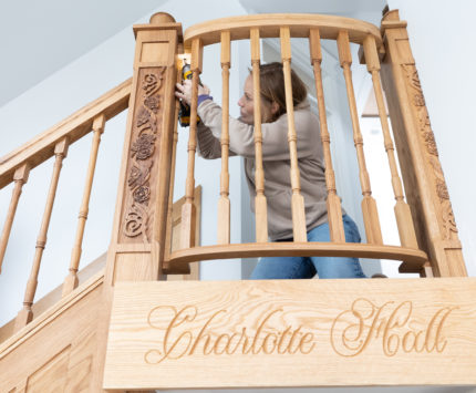Mina Starsiak Hawk helps install a Juliet balcony in the historic Sander’s House.