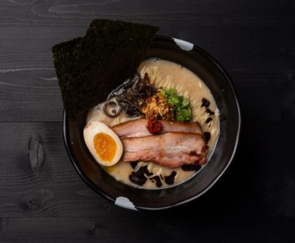 bowl of ramen with meat, noodles, and soft egg